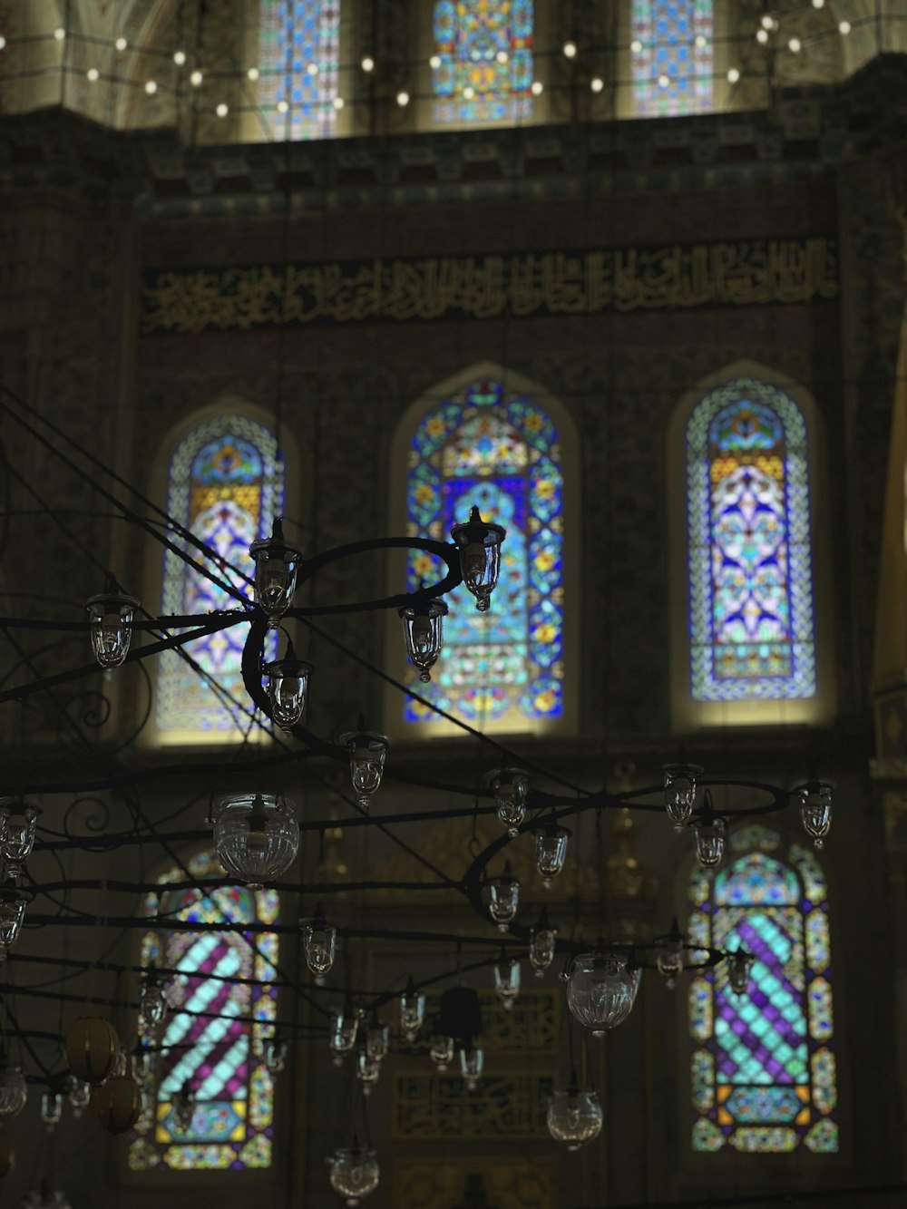 a chandelier in front of a stained glass window