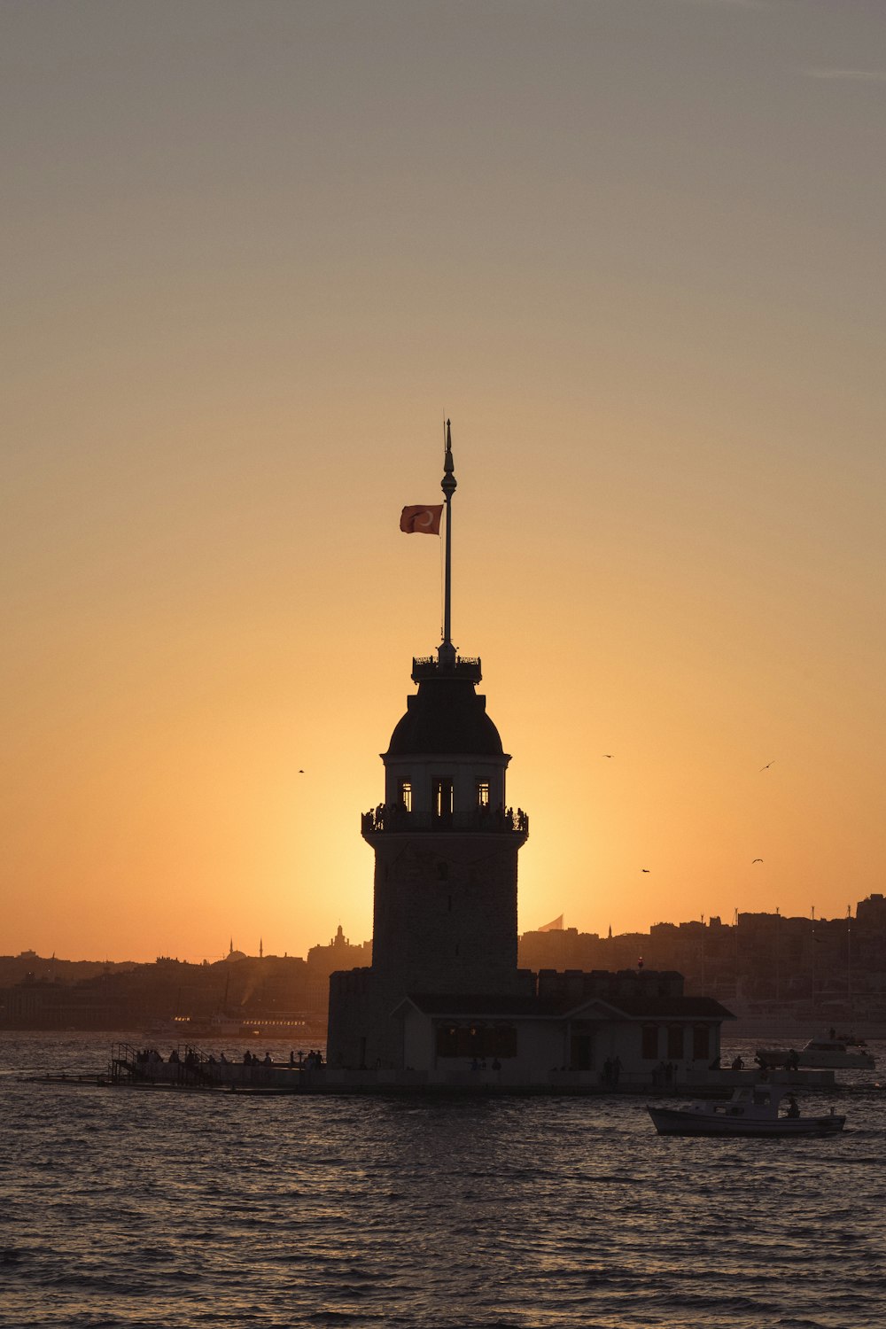 a lighthouse with a flag on top of it