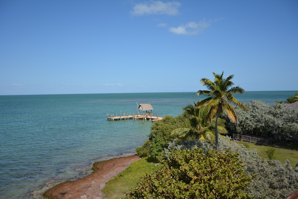 a view of the ocean with a house on the water