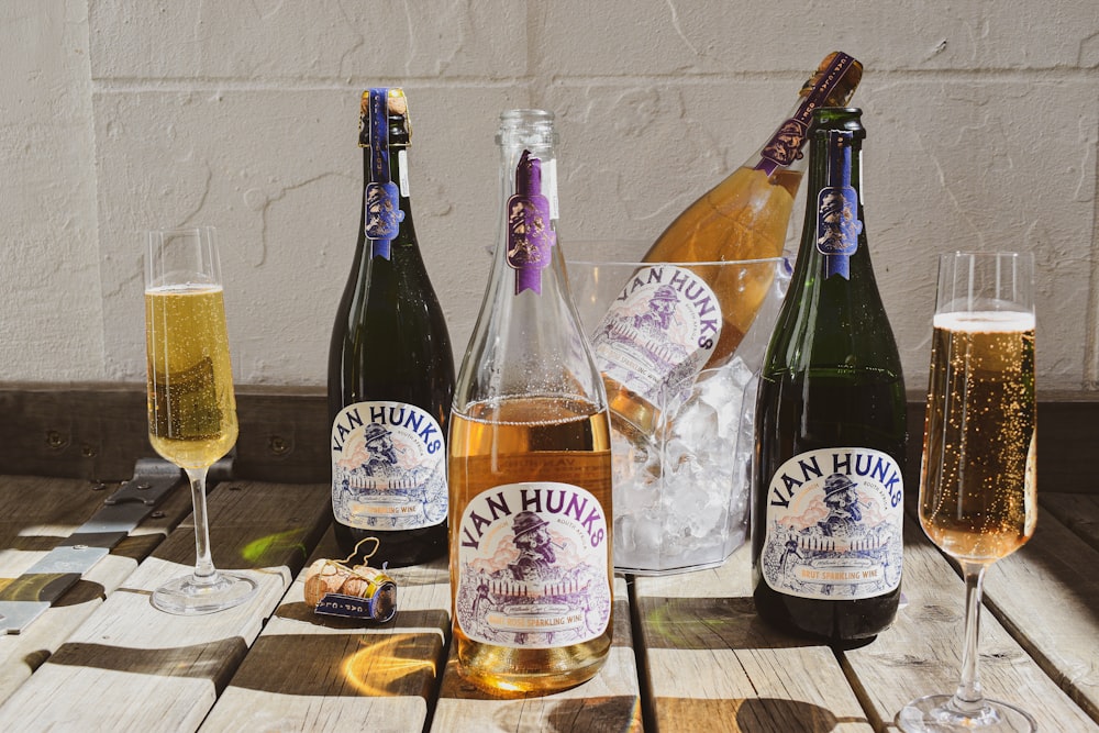 a table topped with bottles of wine and glasses of wine