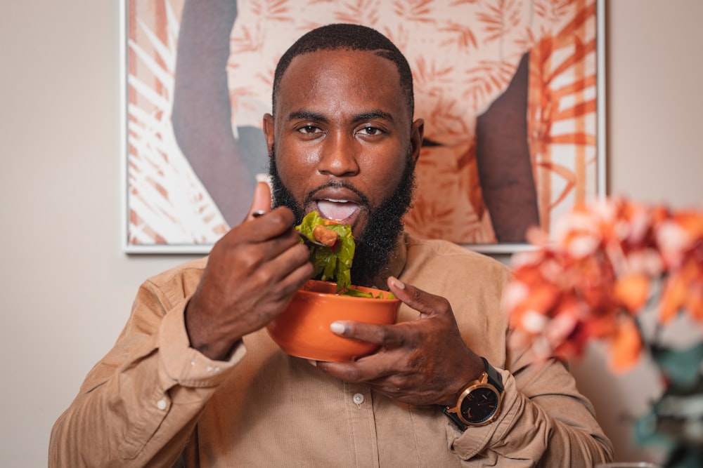 a man holding a bowl of food in his hands