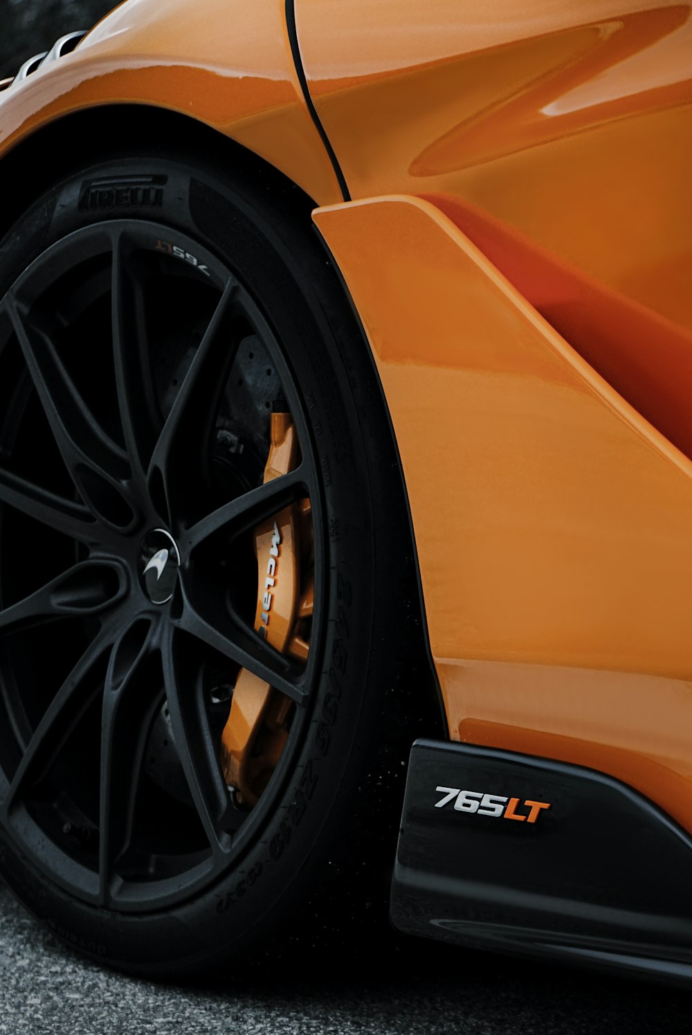um close up das rodas dianteiras de um carro esportivo