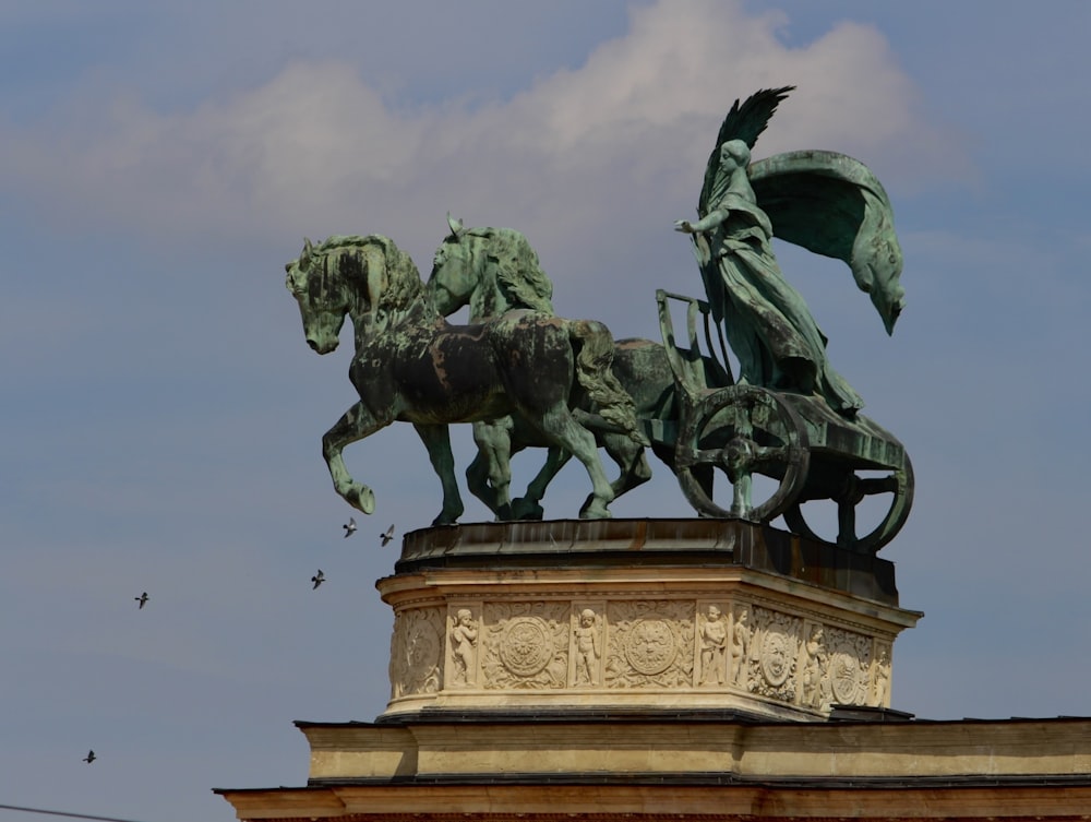 a statue of a man on a horse with a bird flying by