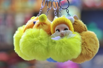 A vibrant display of cute animal bag charms in pink and purple.