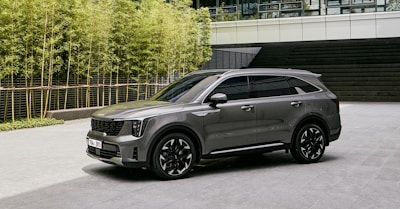 a grey suv parked in front of a building