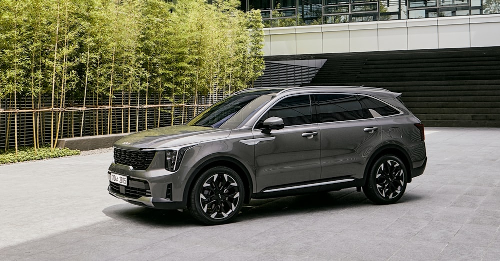 a grey suv parked in front of a building