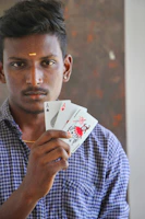 Close-up of a player's hand holding three cards during a tense moment in the game.