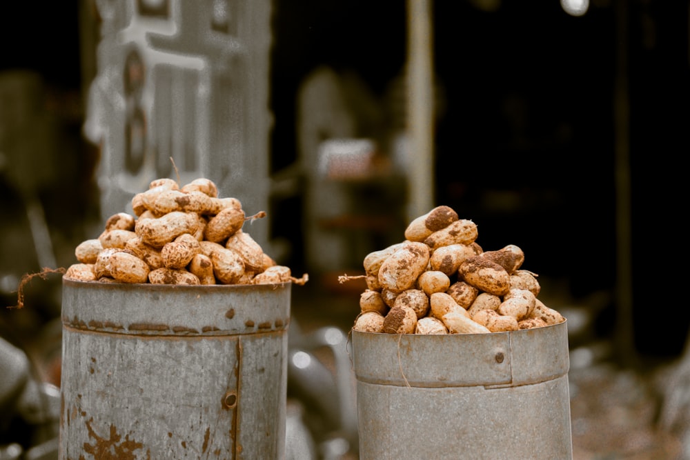 a couple of metal buckets filled with food