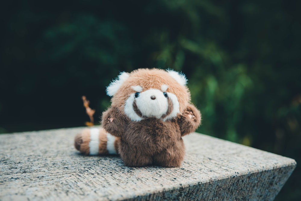 a stuffed animal is sitting on a ledge