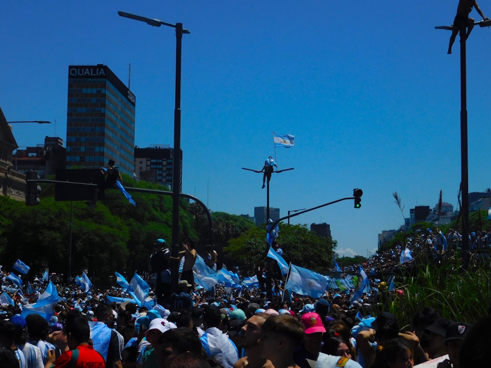 a large group of people standing on top of a street