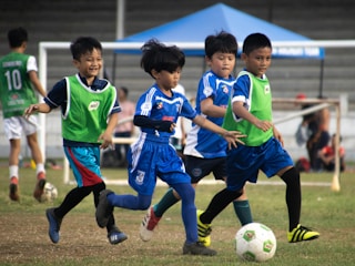 a group of young children playing a game of soccer