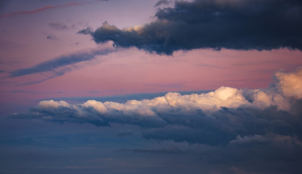 a plane flying in the sky with a lot of clouds