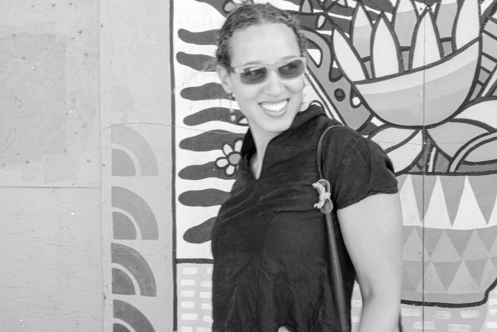 a woman standing in front of a colorful wall