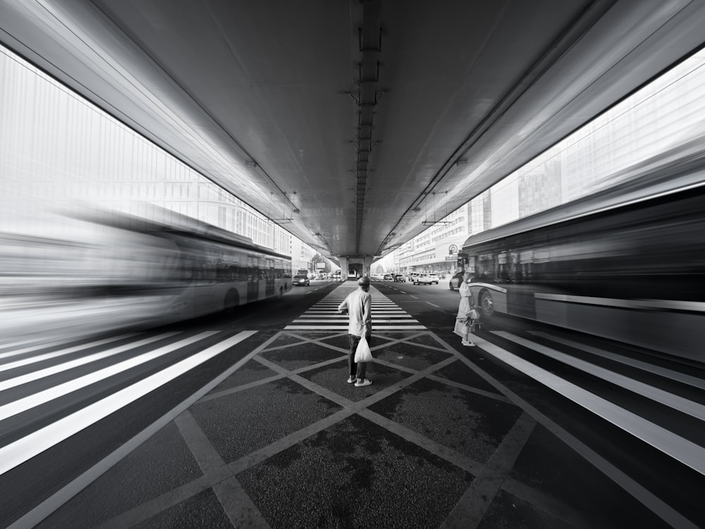 a person standing in the middle of a tunnel