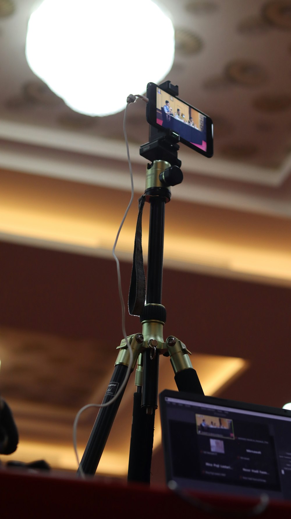 a tripod with a camera and a laptop on it