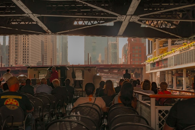 A group enjoying a lively boat tour along Dubai Creek with cityscape in the background.