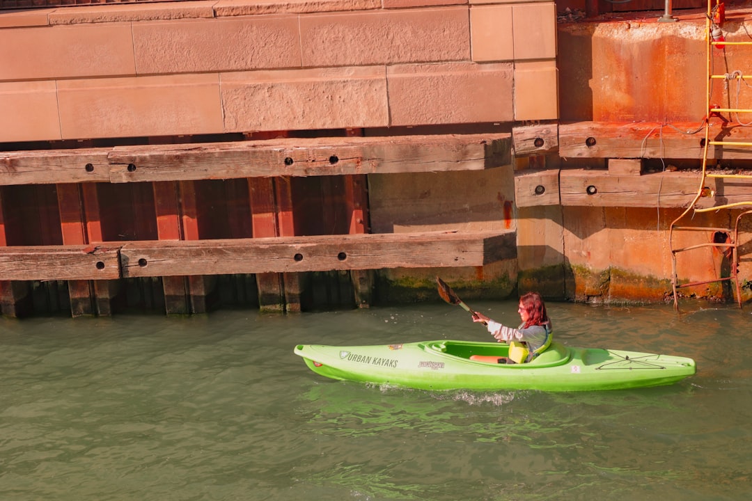 a person in a green kayak in a body of water,