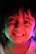 Close-up of a smiling child inside the immersive balloon, surrounded by vibrant visuals.