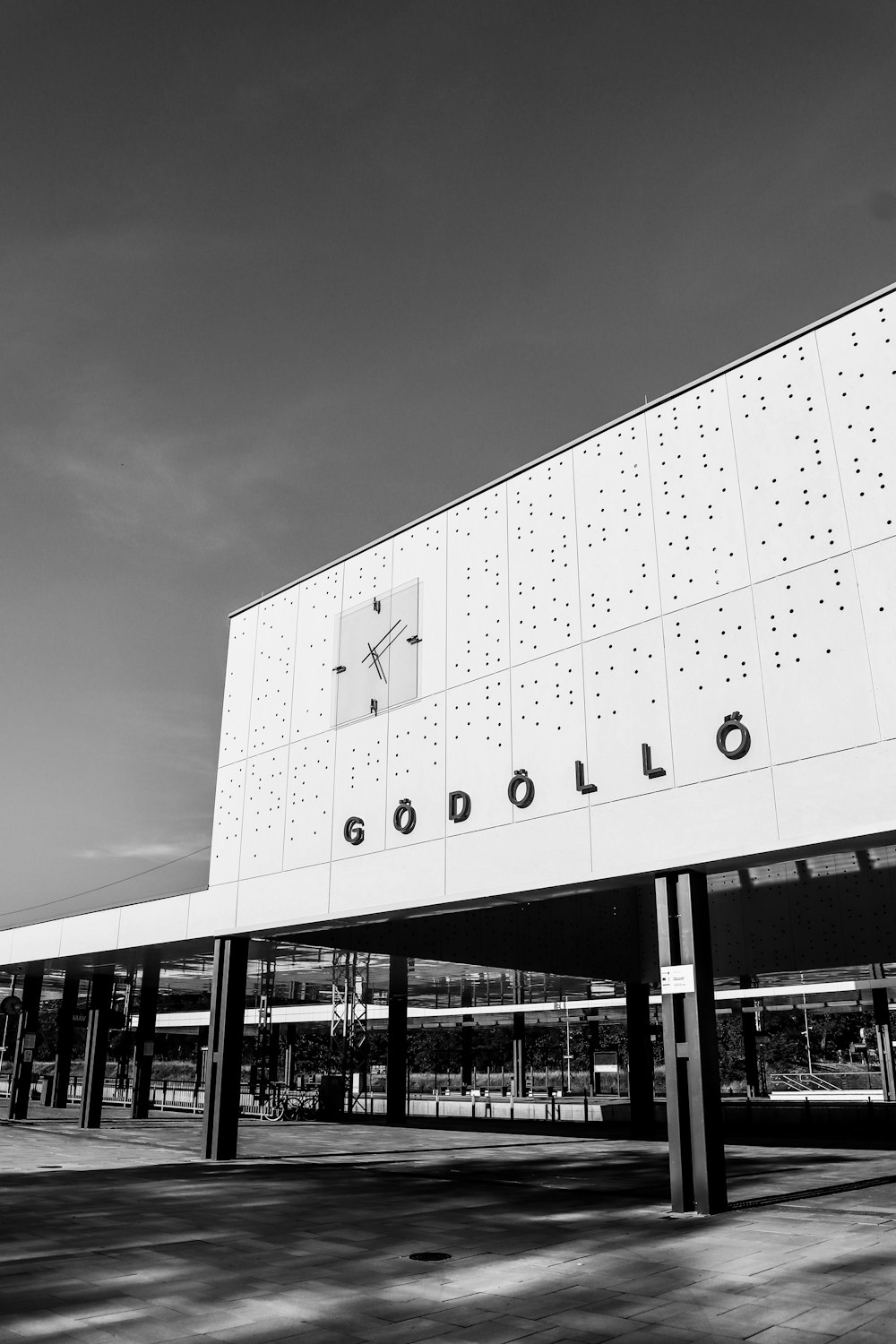 a black and white photo of a building with a clock on it