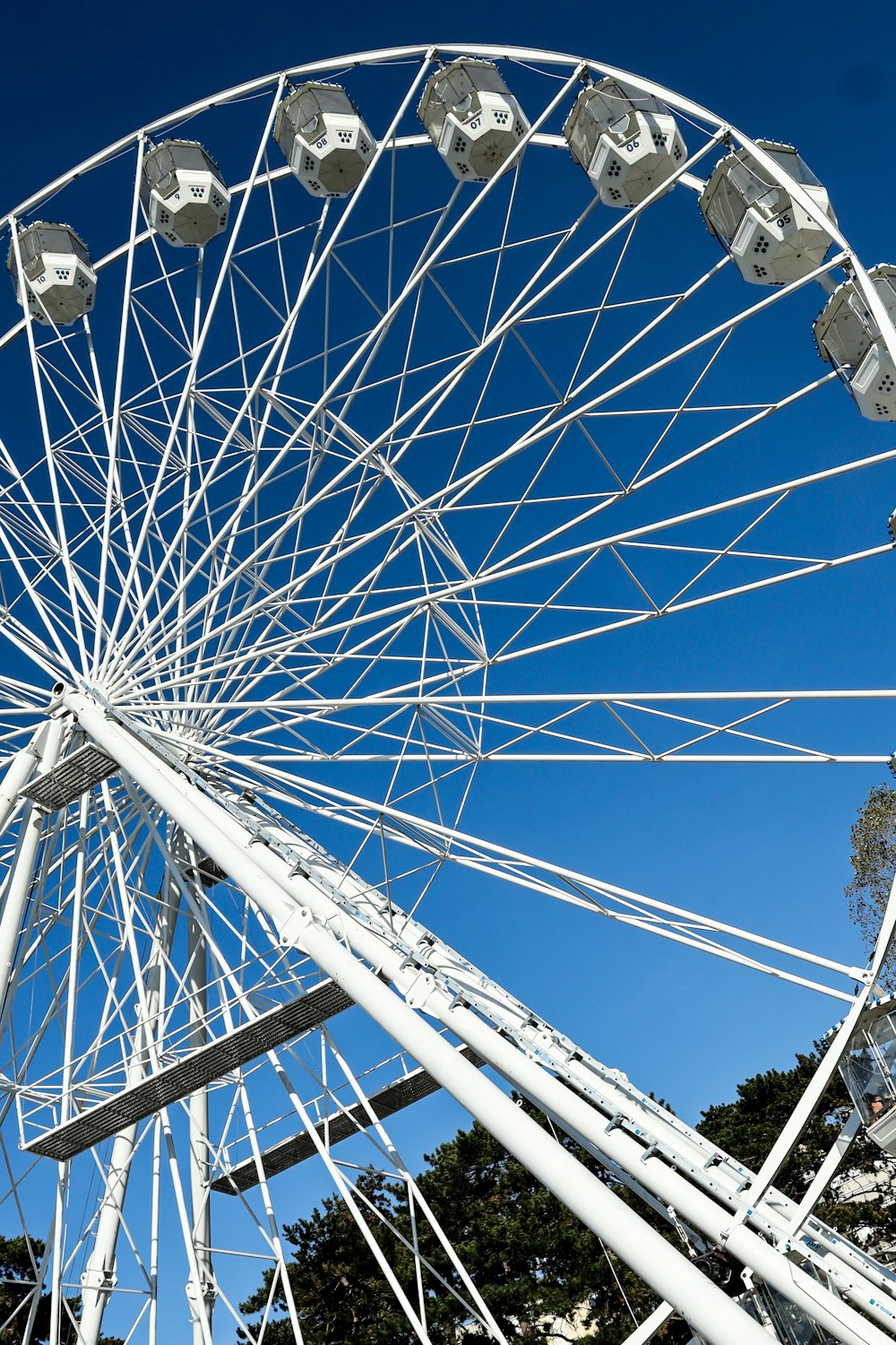 a white ferris wheel against a blue sky