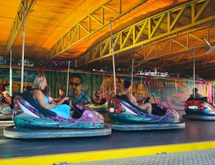 a group of people riding bumper cars in a carnival