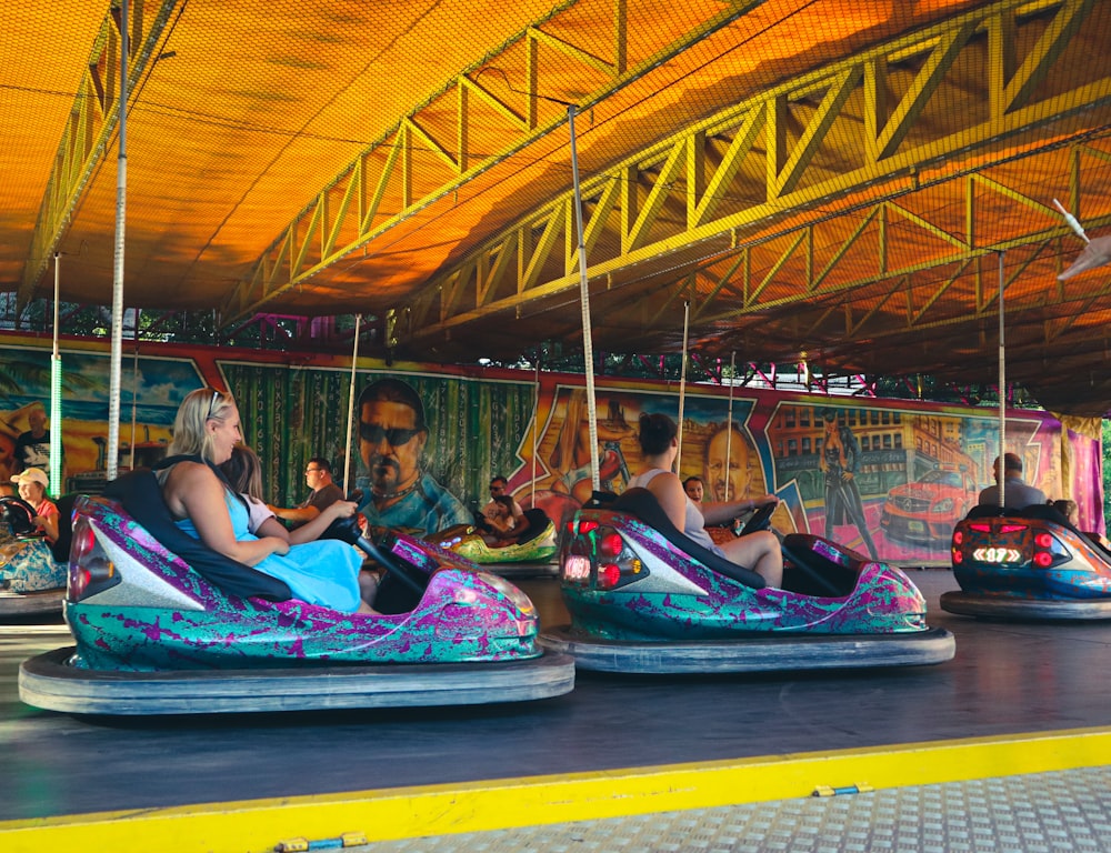 a group of people riding bumper cars in a carnival