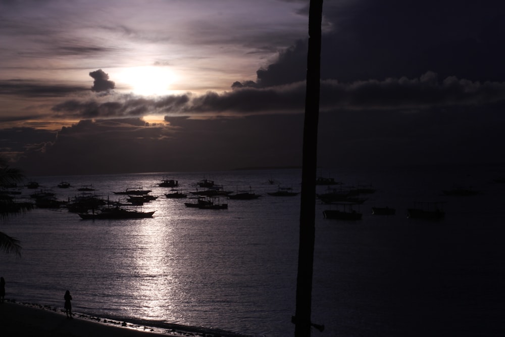 a group of boats floating on top of a body of water