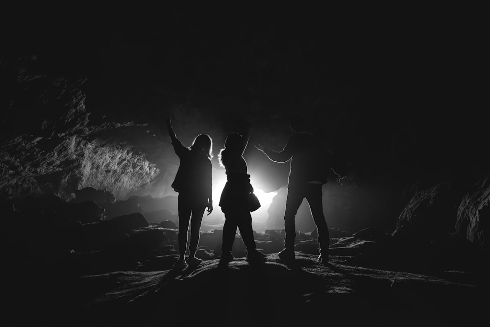 a group of people standing in a cave