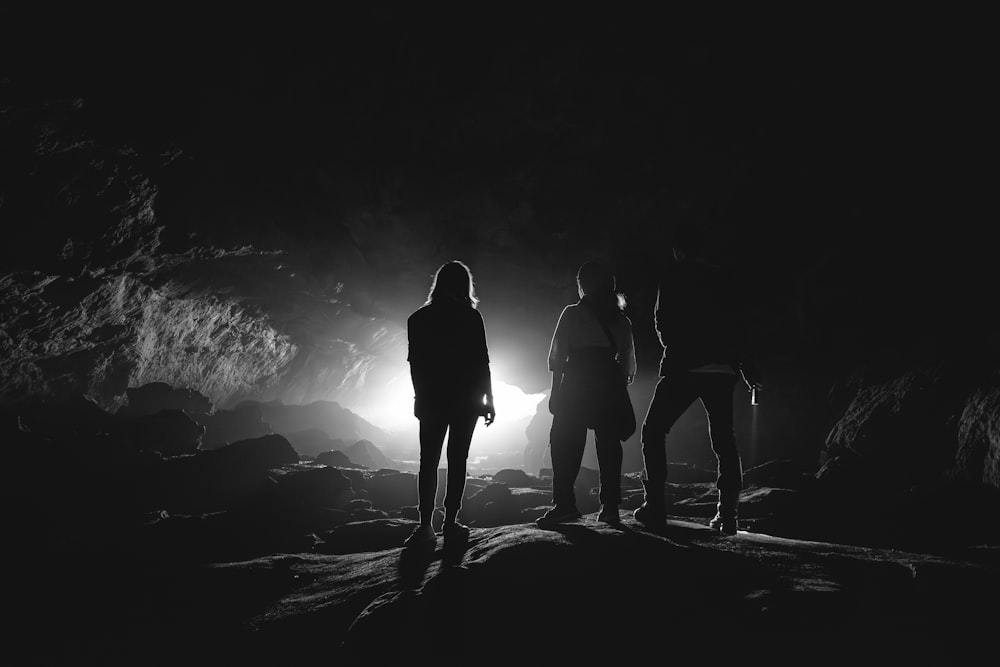 a group of people standing in a cave