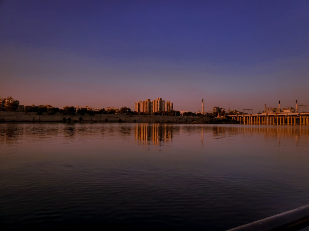 a body of water with a city in the background