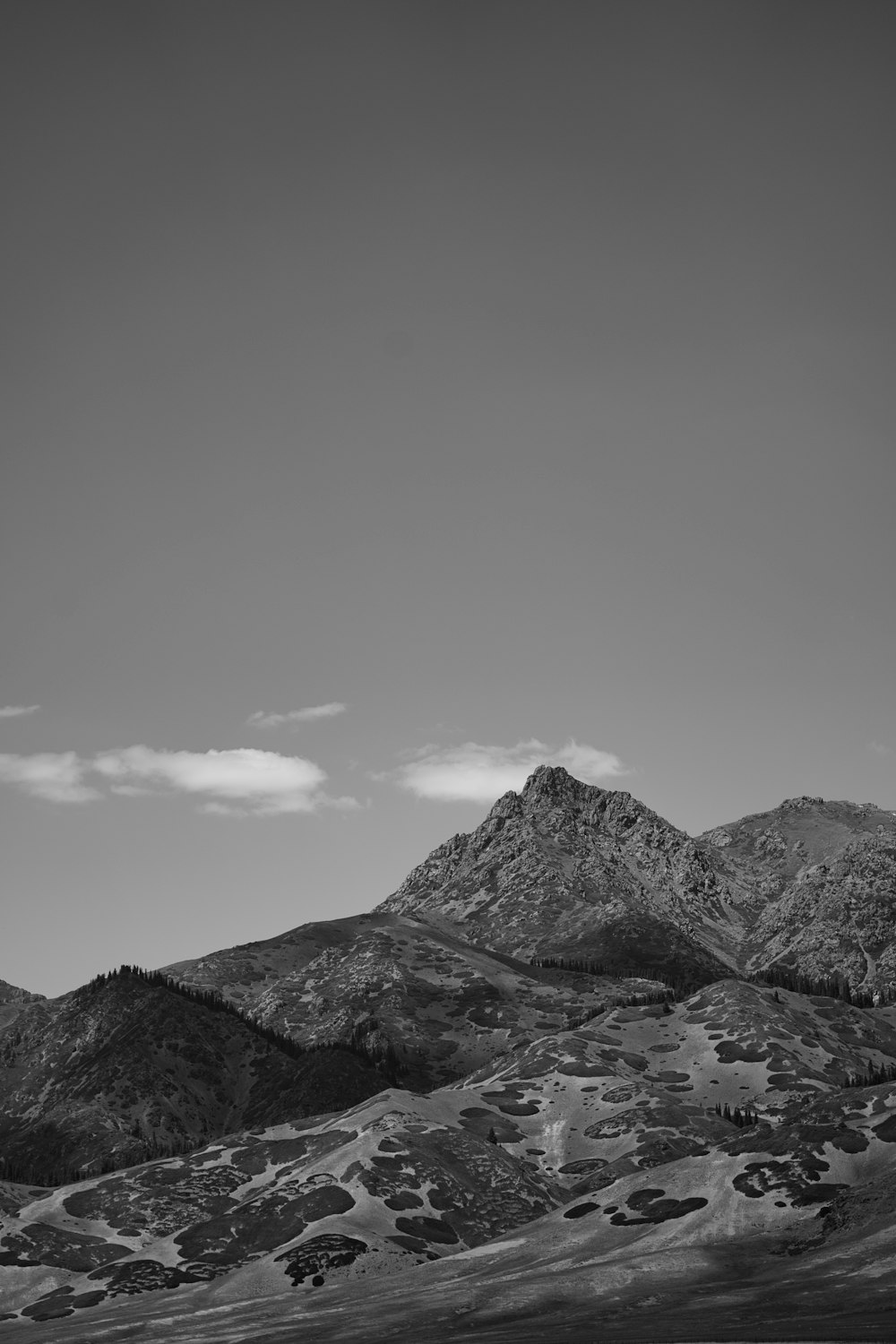 a black and white photo of a mountain range