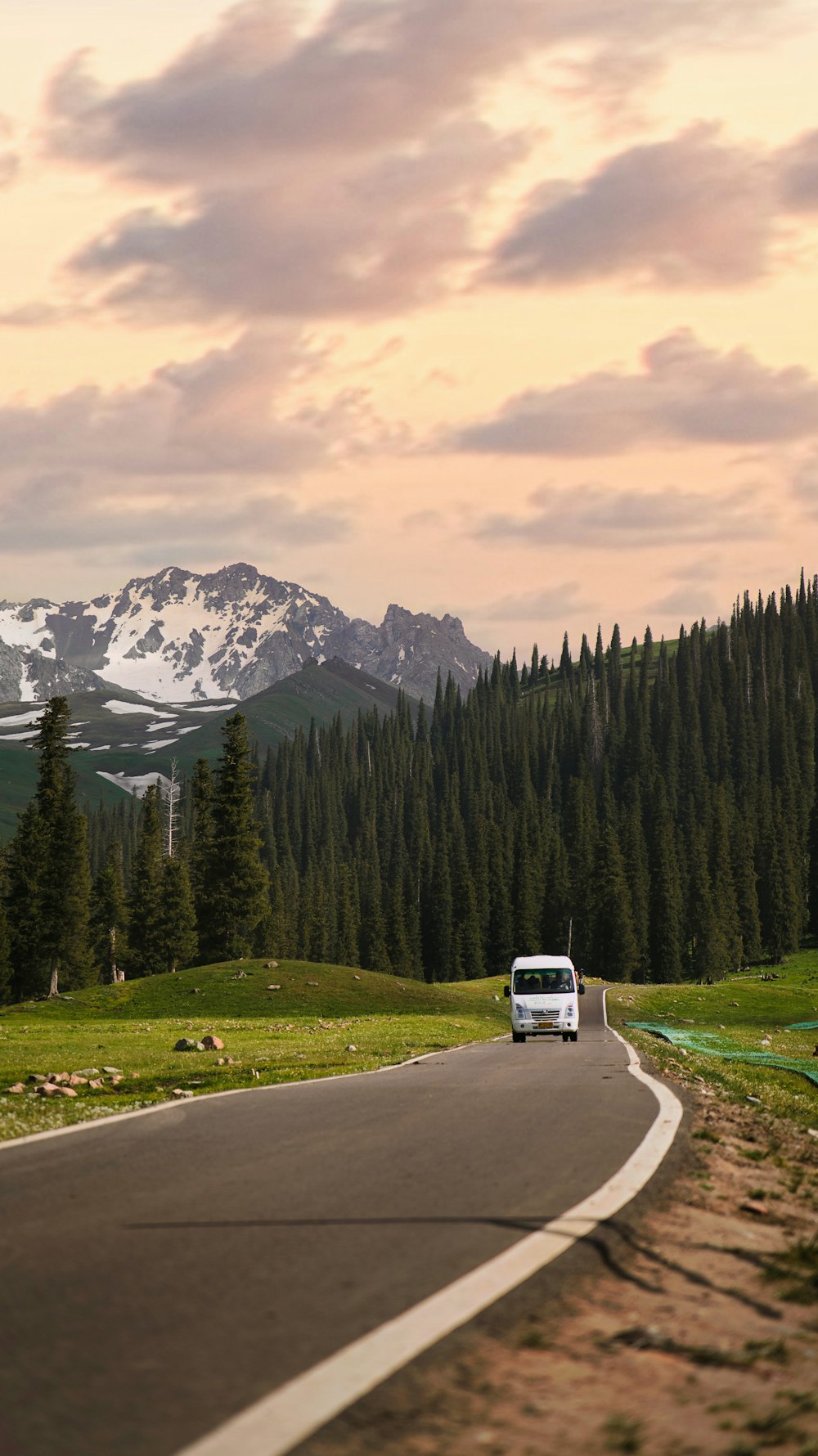 a van driving down a road in the mountains