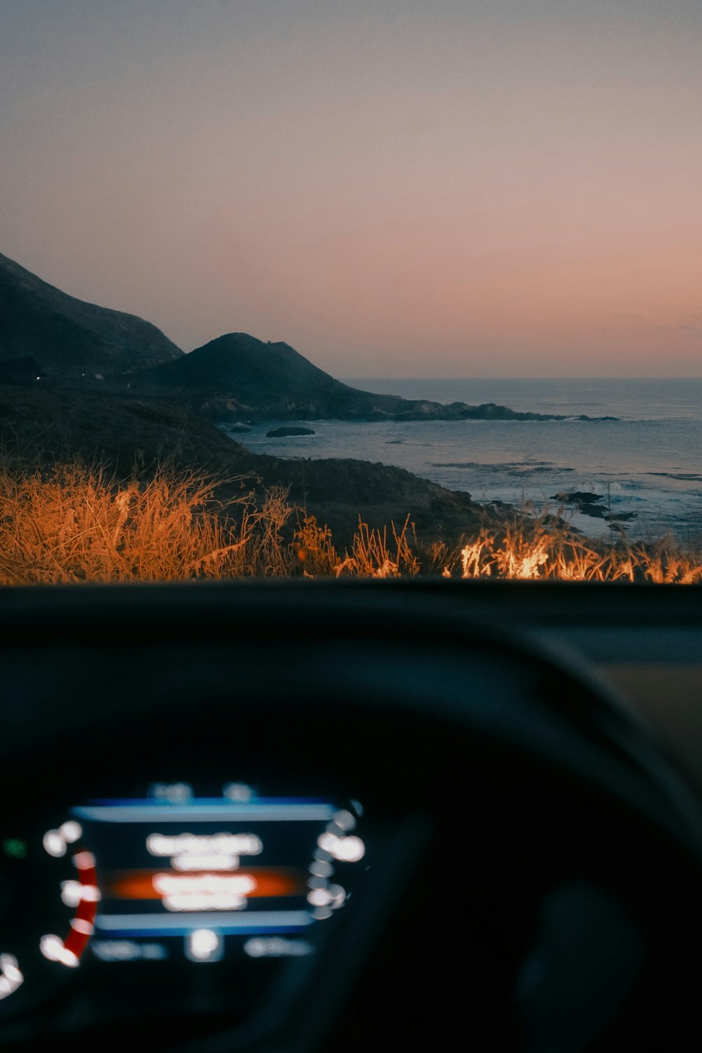 a view of the ocean from inside a car