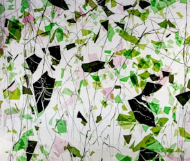 An abstract composition featuring a multitude of geometric shapes in varying shades of green and pink. Interspersed throughout are irregular black shapes, creating a striking contrast against a predominantly white background. Thin black lines crisscross the image, adding an organic complexity to the scene.