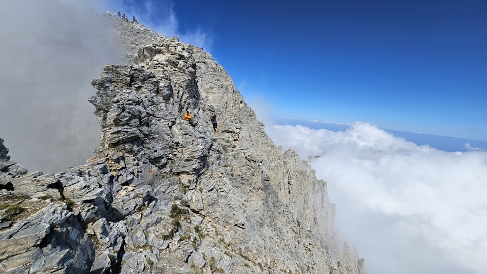 a group of people standing on top of a mountain