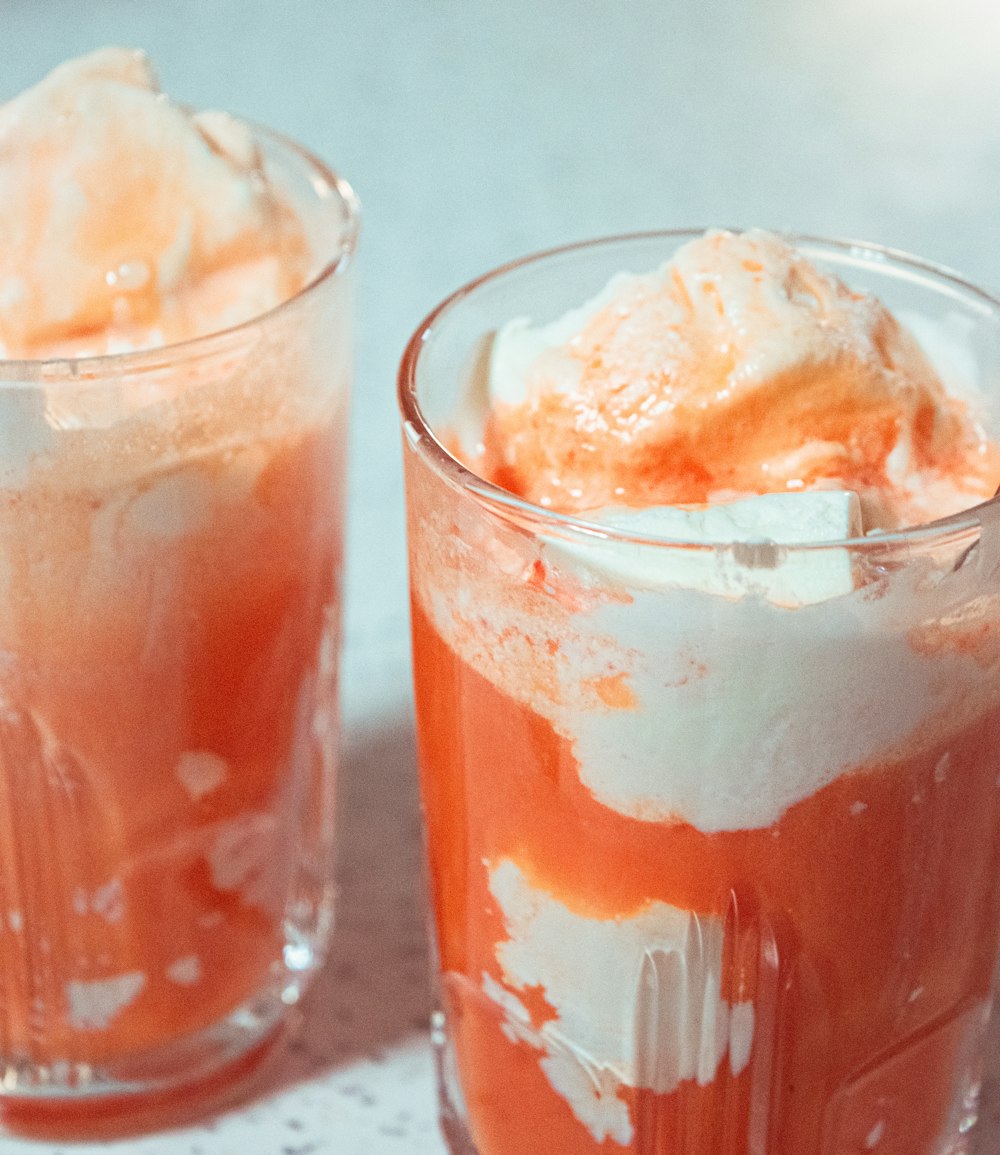 a couple of glasses filled with food on top of a table