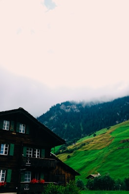 A cozy four-bedroom house nestled at the foot of a mountain with vibrant traditional Zulu decorations on the porch.