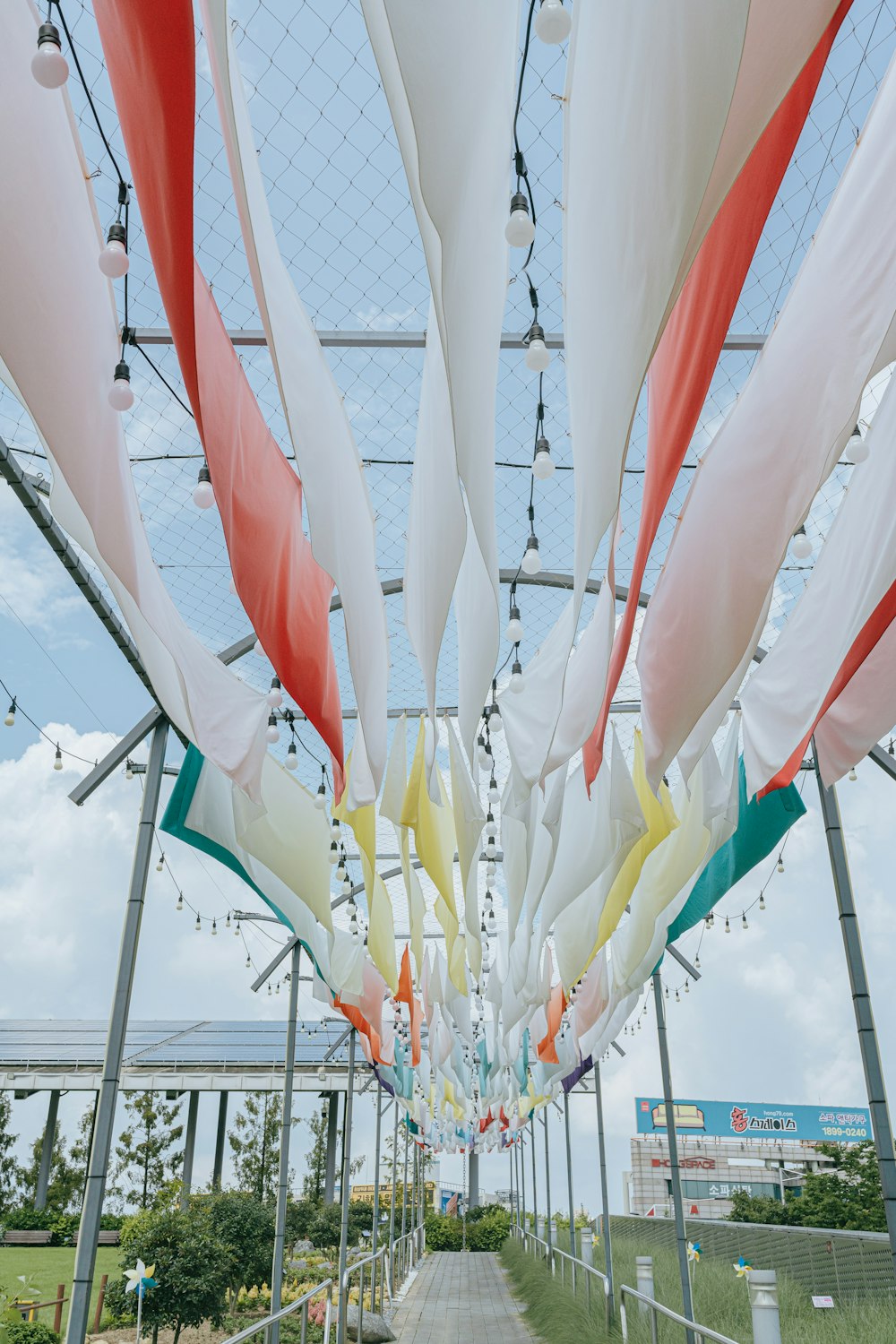 a walkway lined with lots of white and red flags