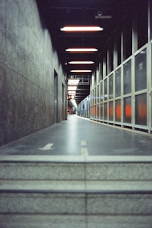 A long hallway with a concrete floor and walls.