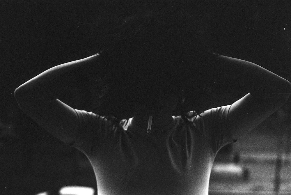 a black and white photo of a person with their back to the camera