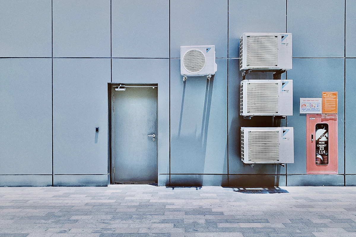 Wall-mounted outdoor HVAC condenser units