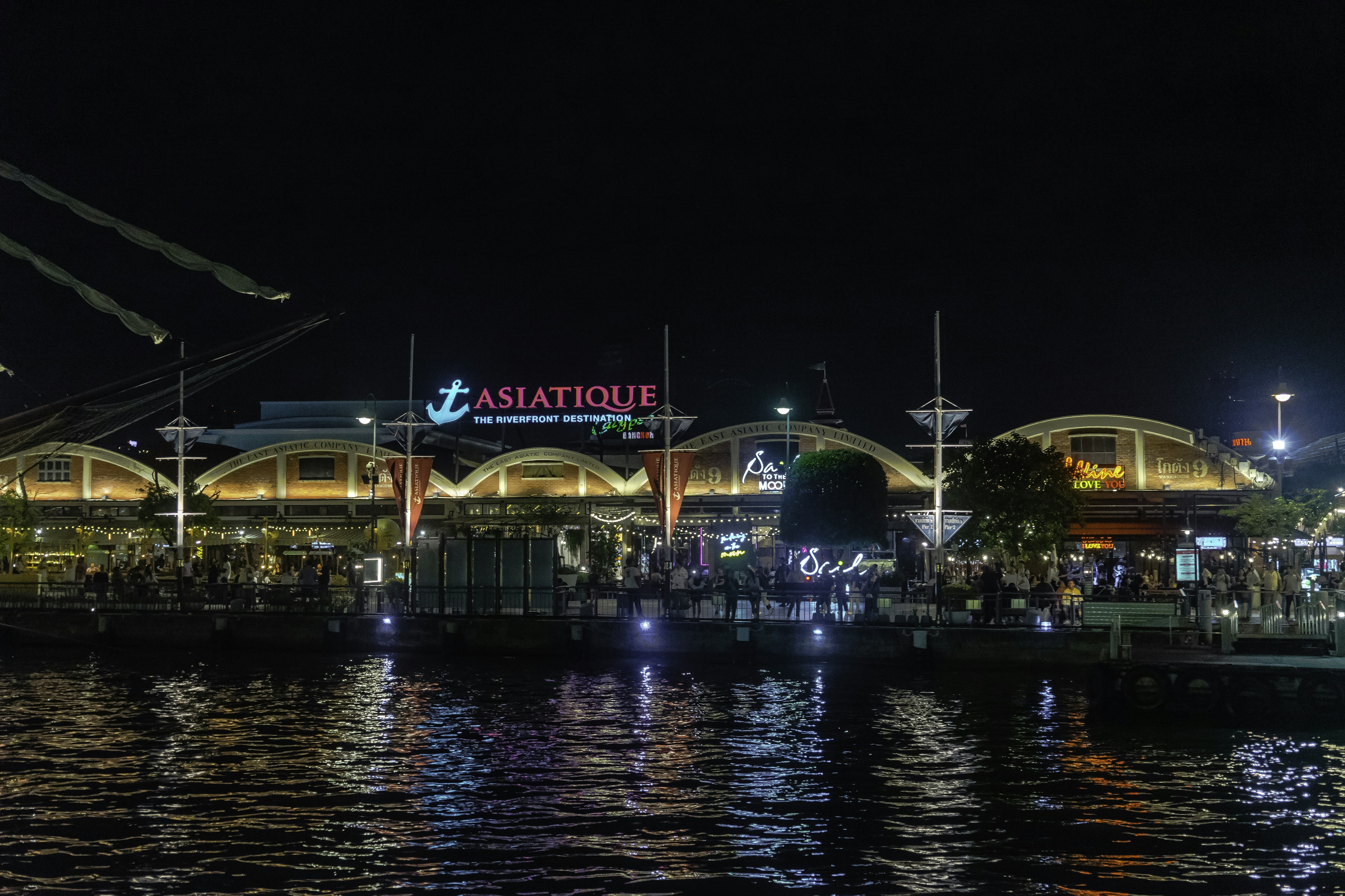 a night view of a restaurant on the water