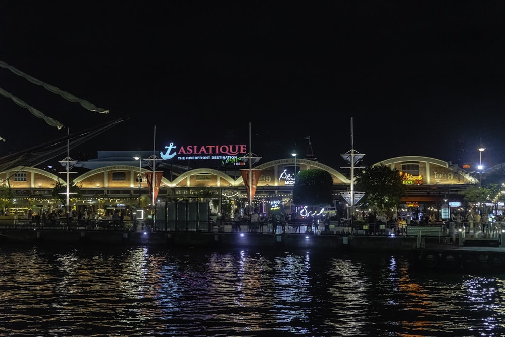 a night view of a restaurant on the water