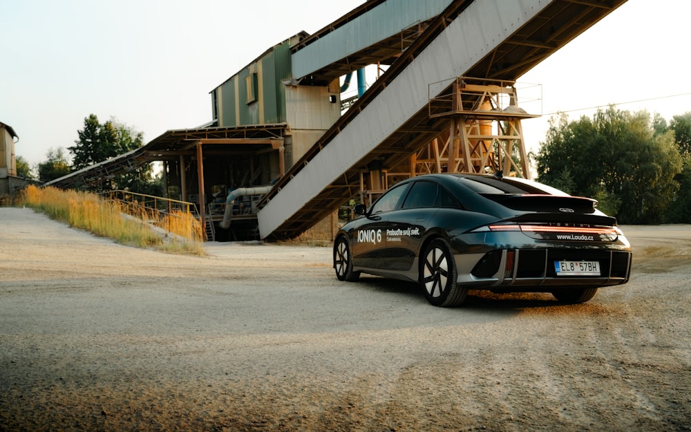 a black car parked in front of a building