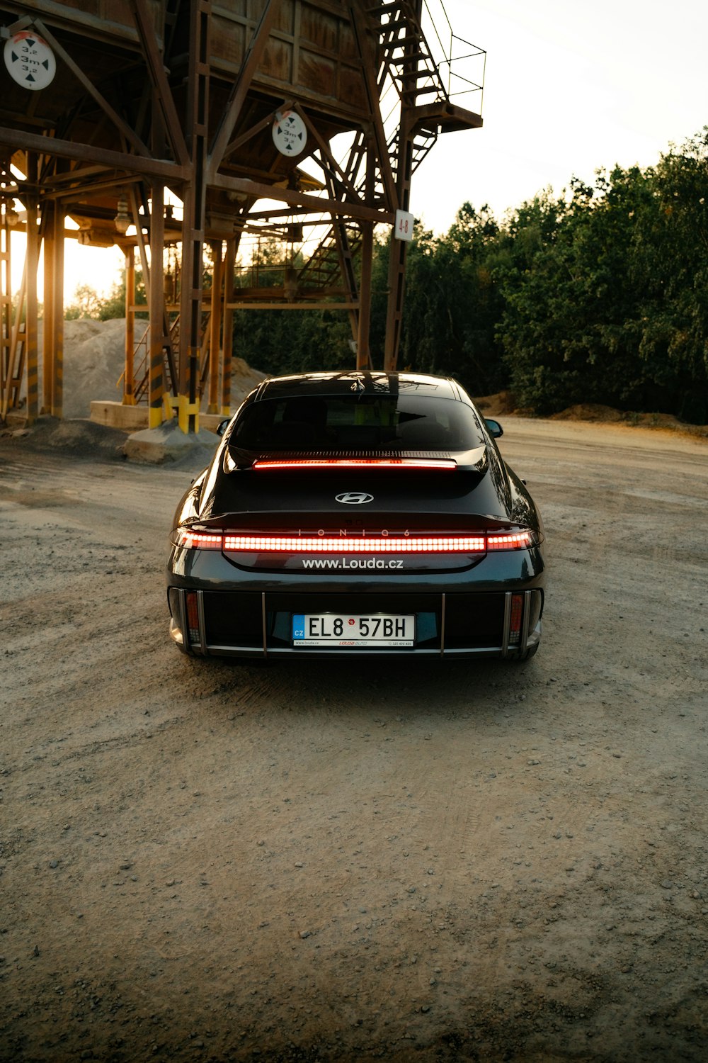 a car parked in front of a wooden structure