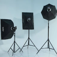 Modern studio interior featuring adjustable light stands and props.