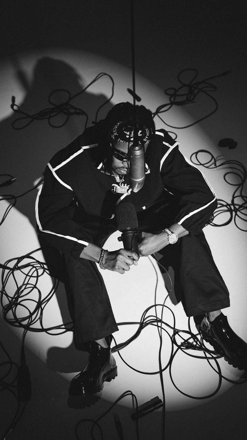 a man sitting on top of a table covered in wires