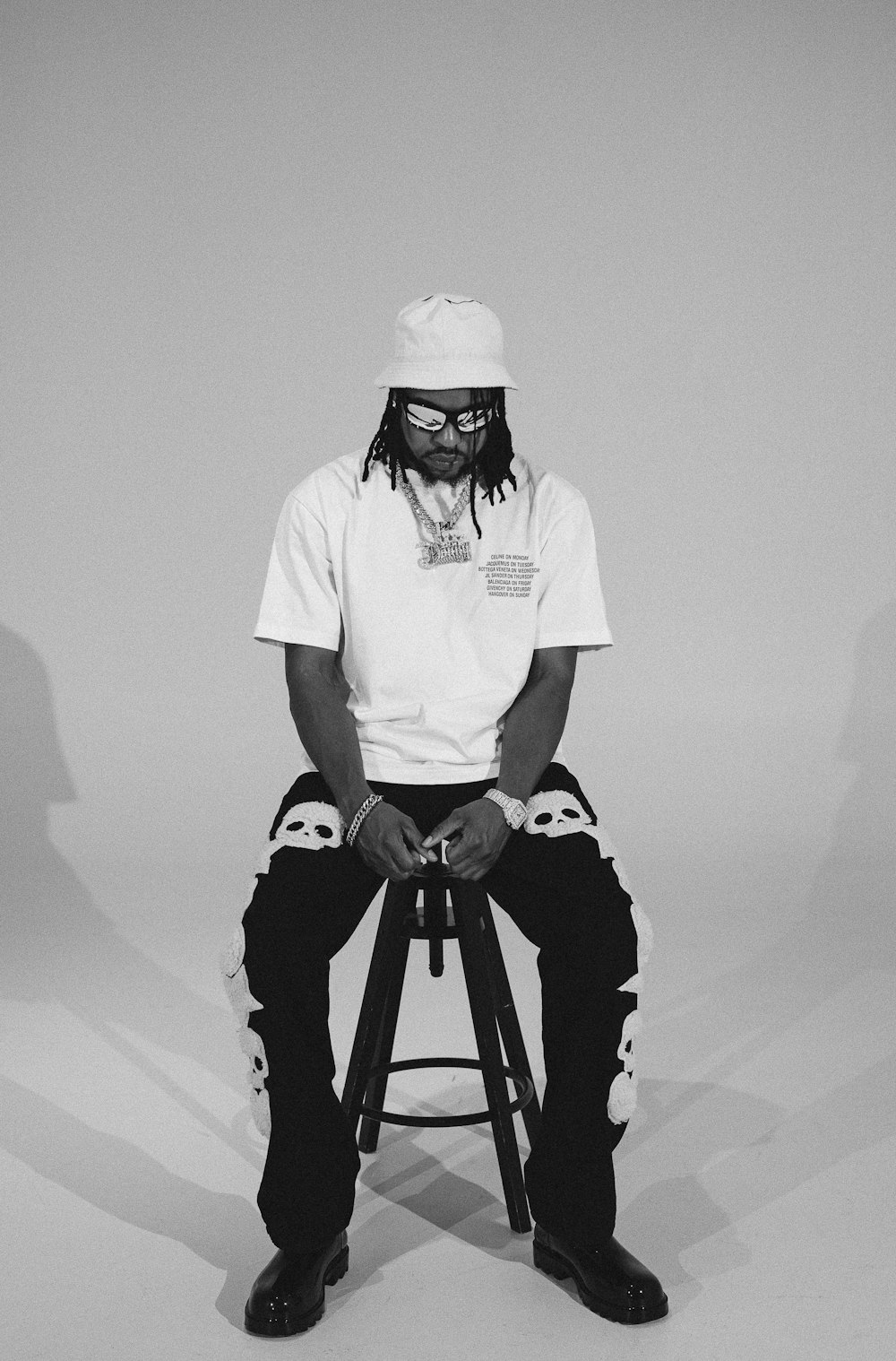 a man sitting on top of a stool