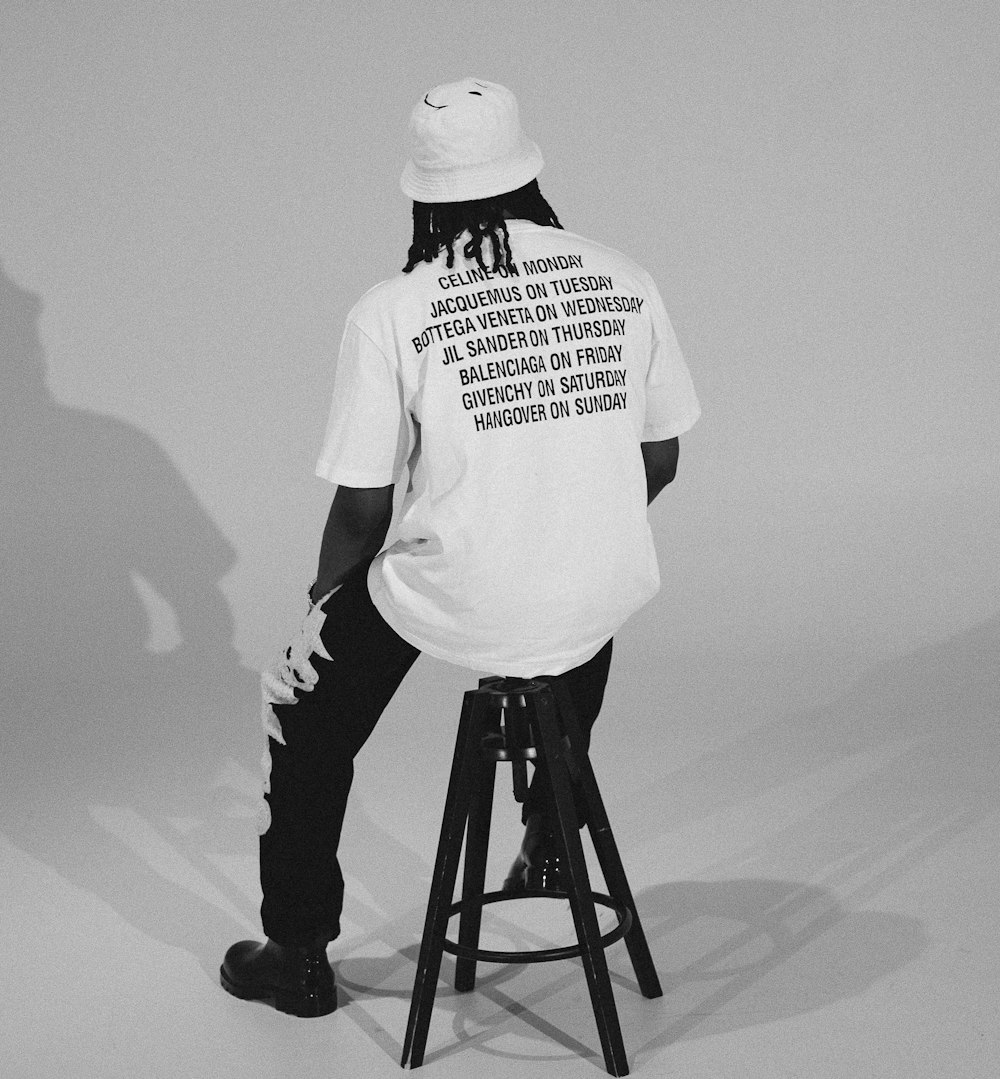 a man sitting on top of a stool