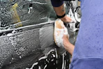 a man washing a car with a sponge